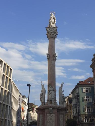 a statue on top of a pole in a city at Apartment Serlesblick in Ellbögen