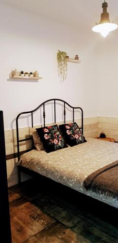 a bed with two pillows on it in a room at Sinaia Veche in Sinaia