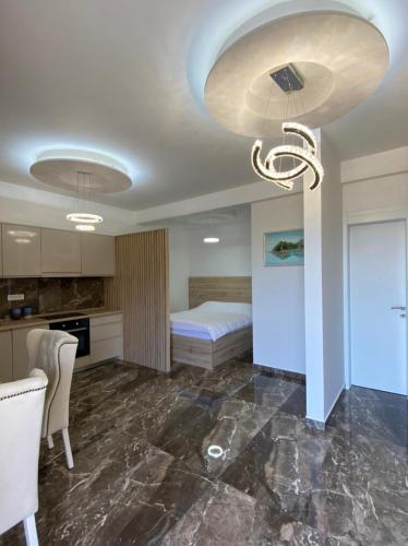 a bedroom with a bed and a kitchen with at VILLA MILENA in Kotor