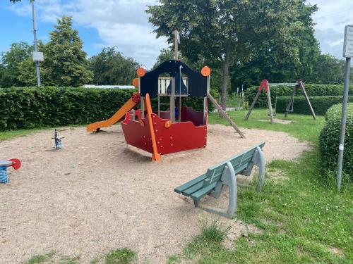 a small playground with a slide and a bench at Lieblingsplatz Koblenz in Koblenz