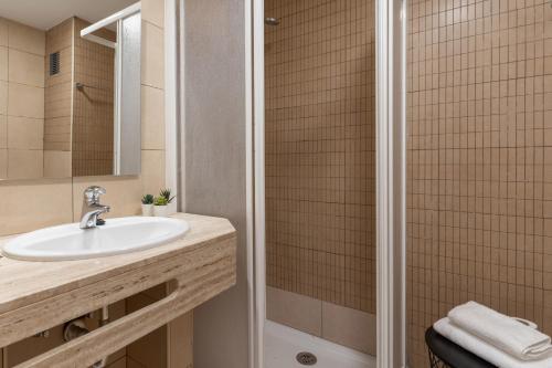 a bathroom with a sink and a shower at Apartamentos Venecia in Lloret de Mar