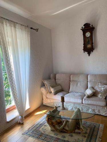 a living room with a couch and a glass table at Villa Castello Rausch in Poreč