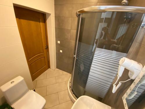 a bathroom with a shower and a toilet at ApartHotel Riga in Rīga