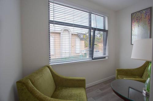 a living room with a chair and a table and a window at Comfy Studio with Cali King Size Mattress in San Diego