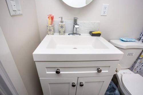 a bathroom with a white sink and a toilet at Comfy Studio with Cali King Size Mattress in San Diego