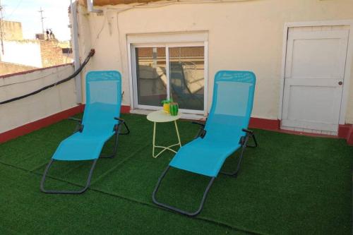three chairs and a table in a room with green grass at Reus, amazing apartment in the city centre. in Reus