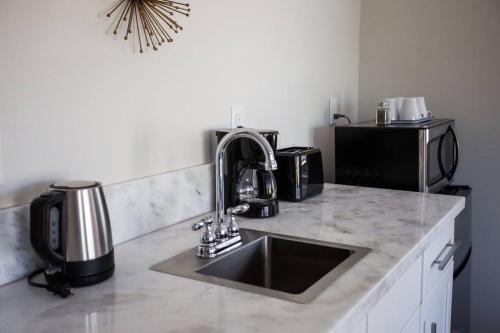 a kitchen counter with a sink and a microwave at Cozy Studio next to San Diego DT and Balboa Park in San Diego