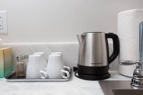 a kitchen counter with a coffeemaker and a coffee pot at Centrally Located Cozy Studio Apartment in SD in San Diego