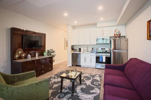 a living room with a purple couch and a kitchen at 1-Bedroom with Cali King Size Bed in San Diego in San Diego