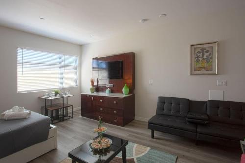 a living room with a couch and a table at Lovely Studio w Full Kitchen in Heart of San Diego in San Diego