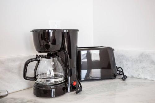 a blender on a counter next to a microwave at Luxurious Design One Bedroom Apt near Balboa Park in San Diego