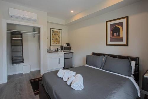 a bedroom with a bed with towels on it at Cute Studio With Large Balcony and Great Park View in San Diego