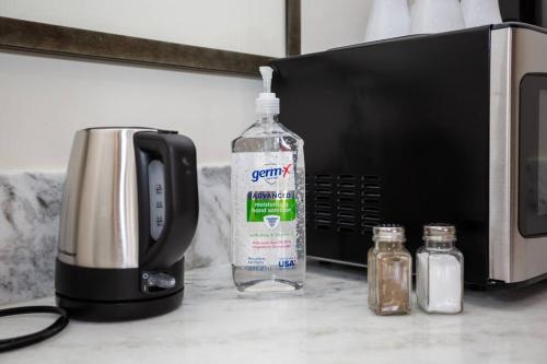 a bottle of water sitting next to a microwave at Cute Studio With Large Balcony and Great Park View in San Diego