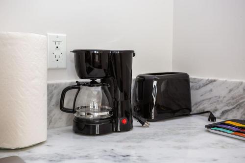 a coffee maker sitting on a counter next to a toaster at Luxurious Studio in Heart of San Diego w Cali King in San Diego