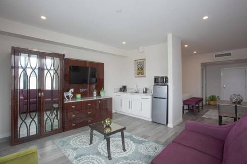 a living room with a purple couch and a kitchen at One Bedroom Apartment with San Diego Downtown View in San Diego