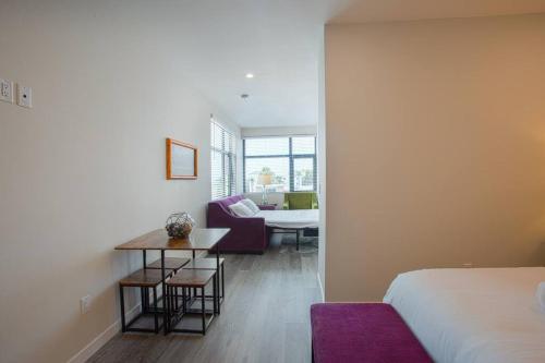 a bedroom with a bed and a table and a couch at One Bedroom Apartment with San Diego Downtown View in San Diego