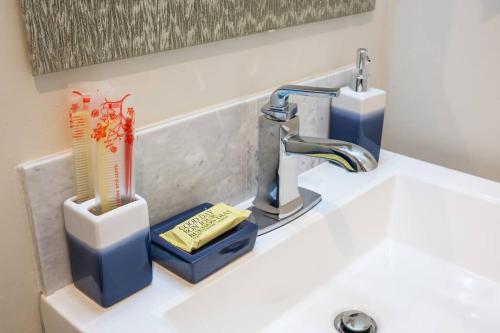 a sink with a faucet and a toothbrush holder at Spacious 1 Bedroom Apartment in Heart of San Diego in San Diego