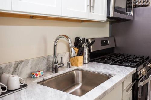 a kitchen with a sink and a stove at Spacious 1 Bedroom Apartment in Heart of San Diego in San Diego