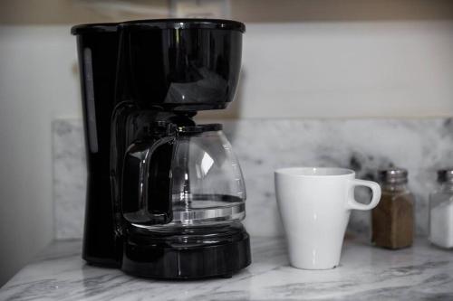 a coffee maker and a cup on a counter at Spacious 500 sqft Studio with Balboa Park View in San Diego