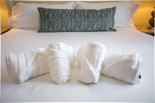 a pile of towels on top of a bed at Spacious 500 sqft Studio with Balboa Park View in San Diego