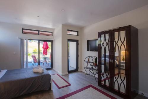 a bedroom with a bed and a sliding glass door at Spacious Studio with Incredible Balboa Park View in San Diego