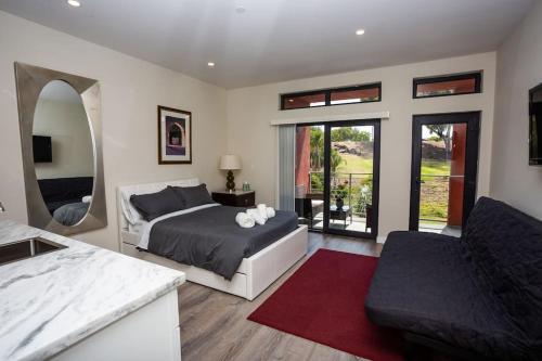 a bedroom with a bed and a living room at Steps to Balboa Park- Brand New Apt - Cozy Studio in San Diego