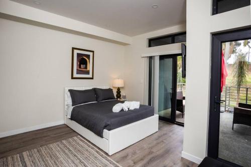 a bedroom with a bed with two pillows on it at Studio with Large Balcony- San Diego Gateway in San Diego