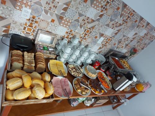 a table filled with lots of different types of food at Hotel e Pousada Magic in Penha