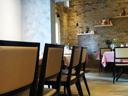 a dining room with tables and chairs and a brick wall at Restaurant Blume in St. Gallen