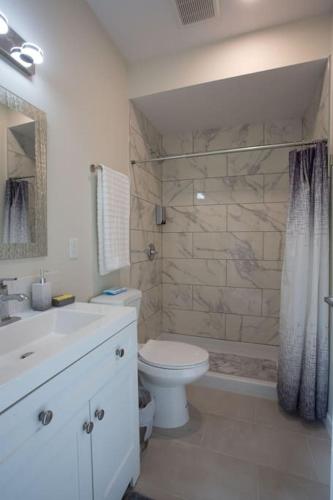 a bathroom with a toilet and a sink and a shower at Explore Balboa Park From Your Cozy Studio w Patio in San Diego