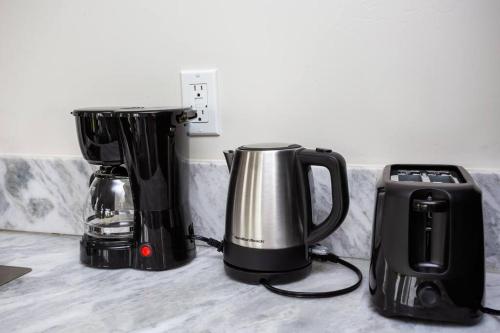 three coffeemakers and a coffee maker and a toaster at Studio with Beautiful View next to Downtown in San Diego