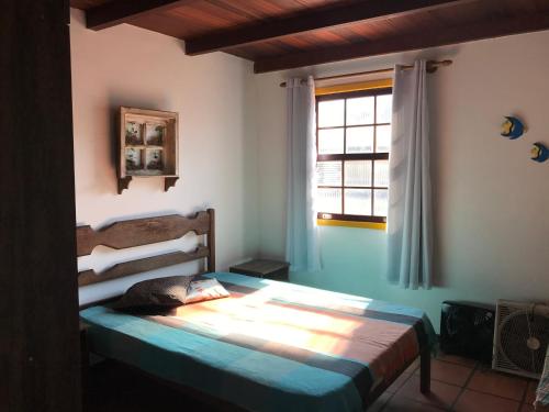 En eller flere senge i et værelse på Apartamento Pero Cabo Frio RJ