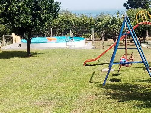 a playground with a slide and a pool at b&b il Maggiolino in Vibo Valentia