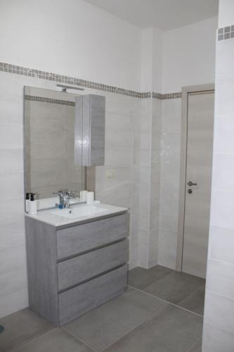 a bathroom with a sink and a mirror at Il giardino del casciar in Castel Volturno