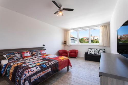 a bedroom with a bed and a ceiling fan at Motel Eldorado in Mikulov