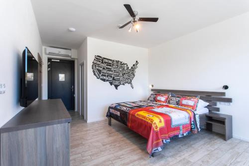 a bedroom with a bed and a ceiling fan at Motel Eldorado in Mikulov