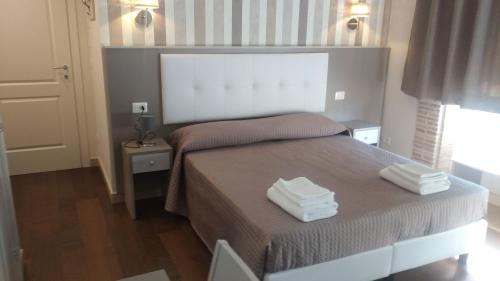 a bedroom with a bed with two towels on it at Il Fortino in Celano