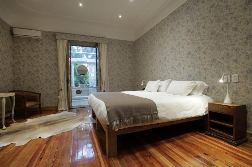 a bedroom with a large bed and a window at Finca Adalgisa in Chacras de Coria