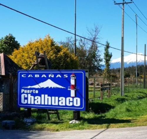 a blue sign for chihuahua on the side of a road at Cabañas Puerto Chalhuaco in Puerto Varas