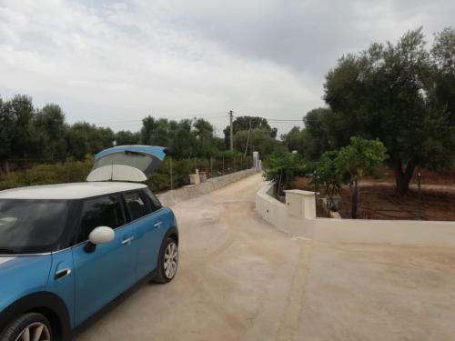 a small blue car parked on a dirt road at Virginia Country house in Specchiolla 