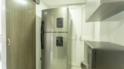 a stainless steel refrigerator in a kitchen next to a counter at APARTESTUDIO MARINARE DE 1 HABITACION CON SALIDA DIRECTA A LA PLAYA m in Cartagena de Indias