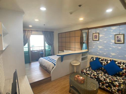 a hotel room with a bed and a couch at CT Theme Suite in Kaohsiung