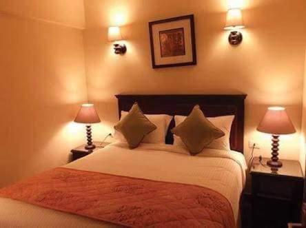 a bedroom with a large bed with two lamps at Porto Sauth Beach Chalets Family,s only AN in Ain Sokhna