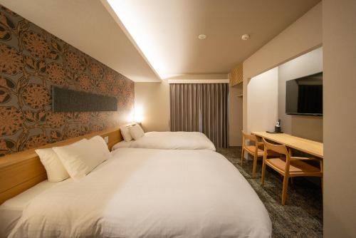 Postel nebo postele na pokoji v ubytování Hotel Celeste Shizuoka