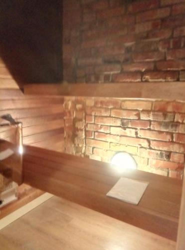 a room with a brick wall and a fireplace at Tähe Maja2 in Viljandi