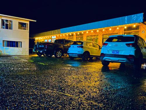 a parking lot with cars parked in front of a building at Cabinas Selva Verde in Monteverde Costa Rica