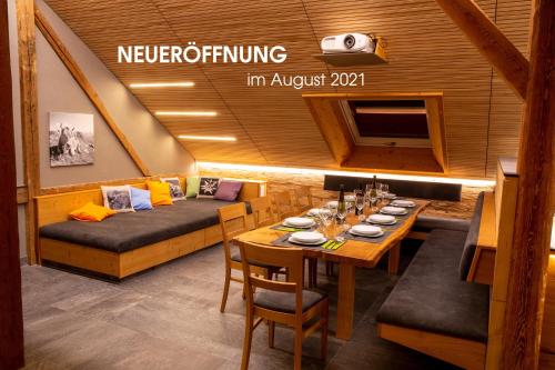 a dining room with a table and a couch at Alpenloft Mereine in Oy-Mittelberg