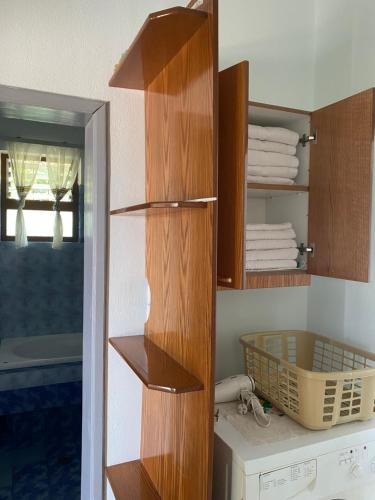 a bathroom with a closet with wooden shelves at Shuko Village House in Sarandë