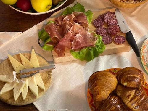 a table topped with cheese and meats and bread at La Magnolia in Greve in Chianti