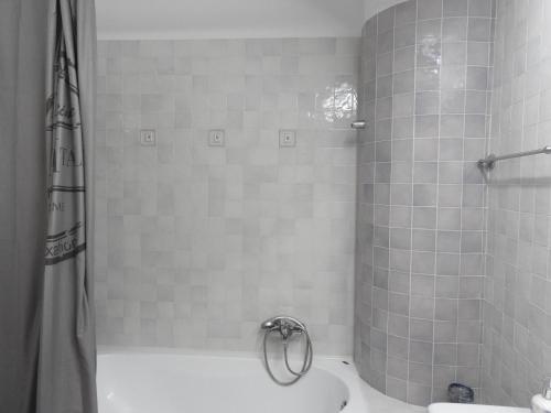 a bathroom with a shower and a tub with a toilet at Aloe Seafront Terrace in Agios Nikolaos